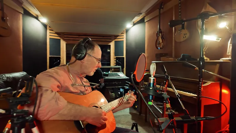 Playing an acoustic guitar in the live room at Temple Cabin Studios
